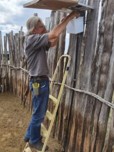 David Mascall installing the battery of the LED (Lion Entry Deterrent System)