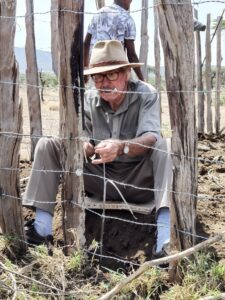 David Mascall sitting in a boma installing Lion Lights